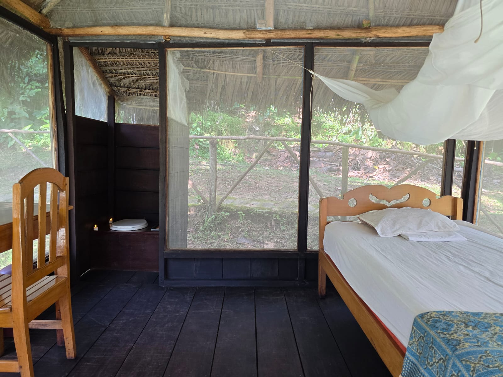 Private tambo interior with bed and mosquito net at Dreamglade